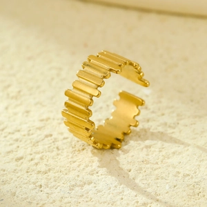 Macro shot of 18K gold plated hollow vertical stripe open ring on stone texture