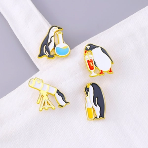 Creative penguin enamel pins set with telescope and juice designs on a white canvas bag