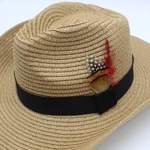 Macro detail of natural straw weave and hat band featuring pheasant feather accents