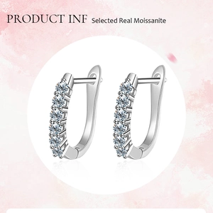 Detail view of U-shaped S925 silver huggie earrings with sparkling moissanite stones