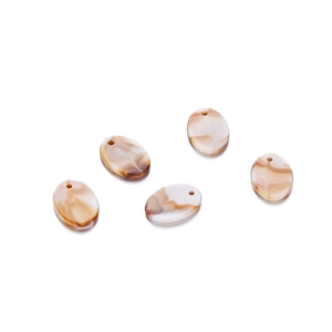 Macro shot of oval acrylic beads with brown marble texture for DIY jewelry making