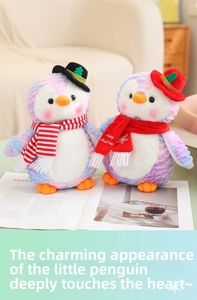Close-up of plush Christmas penguins in purple tie-dye with hats and Merry Christmas scarves