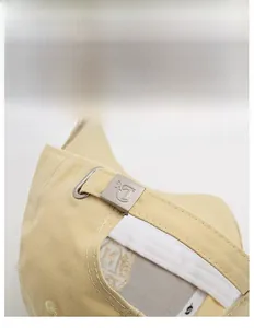 Detail of adjustable metal slider buckle and cotton fabric texture on baseball cap