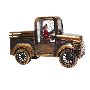 Close-up of vintage bronze Christmas tractor lantern with Santa inside and glitter water