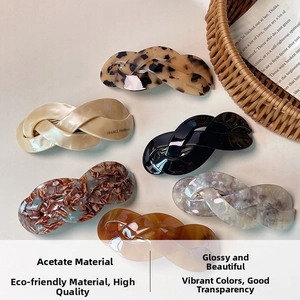 Detailed flat lay of acetate twist hair clips in six vintage tortoise and marble patterns