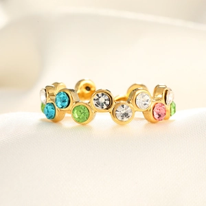 Detailed macro view of gold-plated ring with colorful micro-set cubic zirconia stones