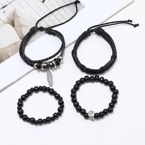Set of four black beaded and leather bracelets with vintage silver leaf pendants