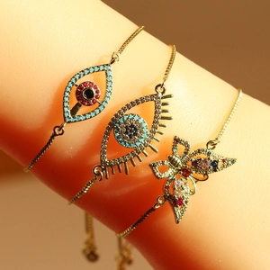 Adjustable gold snake chain bracelet with evil eye and butterfly zircon pendants