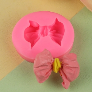 Pink 3D bow silicone mold for fondant chocolate and DIY resin craft with finished bow sample