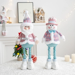 Detailed close-up of pink and blue knit plush Christmas dolls with long textured legs