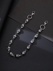 Detail of punk metal skull waist chain with silver skulls and secure lobster clasps