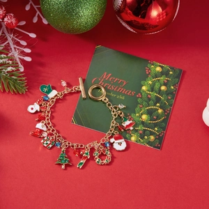 Detailed close-up of Christmas charm bracelet with Santa, tree and reindeer pendants
