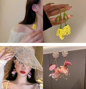 Detail of beaded yellow flower and pink petal pearl tassel earrings on model