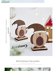 Close-up of minimalist wooden penguin figurines with Santa hats for holiday decor