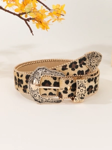 Macro view of leopard print faux fur belt with ornate engraved golden buckle and bead trim