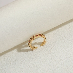 Detail of 14K gold plated ring featuring teardrop and round orange-red zircon stones