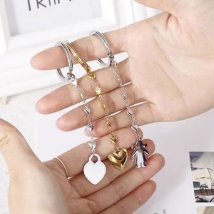 Three creative stainless steel keychains with silver heart and gold 3D heart pendants
