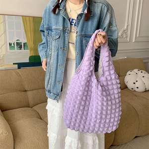 Detailed close-up of purple bubble texture fabric on a large capacity stylish tote bag