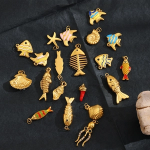 Macro shot of 18K gold octopus and sea life pendants with colorful enamel inlay