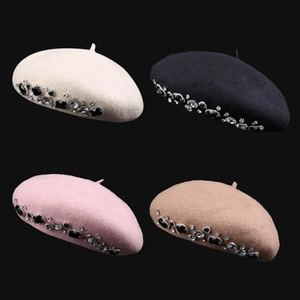 Detail view of sparkly sequin berets in white, black, pink and camel with rhinestones
