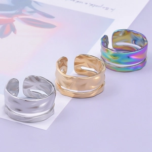 Minimalist geometric textured open rings in silver, gold, and iridescent stainless steel