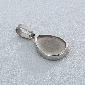 Macro shot of silver teardrop stainless steel pendant base with mounting loop