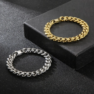 Polished silver and gold Cuban link bracelets for men and women on black background