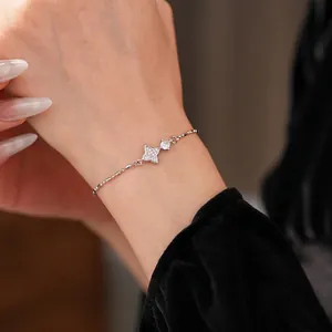 Minimalist silver star bracelet with sparkling zircon stones on a model's wrist