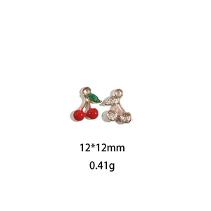 Detailed view of cherry pendants in red enamel and gold with size 12x12mm and weight 0.41g