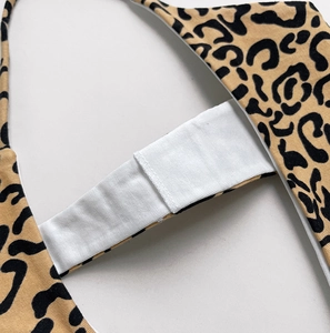 Macro view of leopard print cotton fabric with high-elastic white inner waistband detail