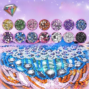 Detail of DIY diamond painting kit showing colorful resin rhinestones and peacock pattern