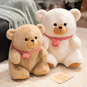 Plush Teddy Bear dolls in light brown and cream with checkered scarves in a home setting