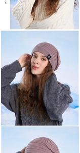 Detail view of light purple knit beanie featuring fine texture and circular brand logo tag