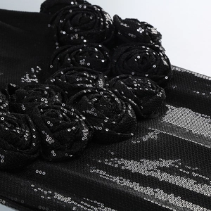 Detail of 3D fabric roses with silver sequins on black pleated mesh party dress