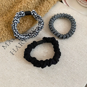 Three-piece hair accessory set featuring woven bands and a black polka dot spiral tie
