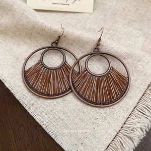Retro bohemian geometric round hollow woven drop earrings in bronze metal and earth tones