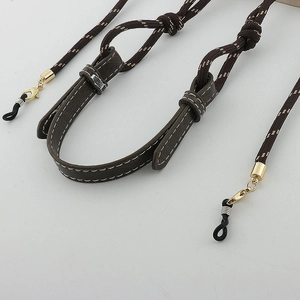 Close-up of dark brown nylon braided glasses chain with gold clasp and rubber loop