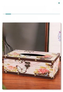 Detail of vintage leather tissue box with rose patterns and brass rivet edges
