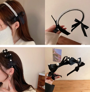 Detail of a pearl headband with a black satin bow and layered ribbon craftsmanship