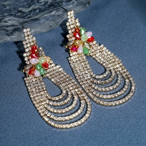 Long tassel earrings with colorful floral stones and crystal rhinestones on blue leather