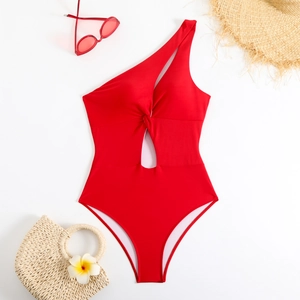 Close-up of red one-shoulder swimsuit with elegant knot detail and chic cutout design