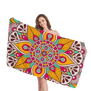 Vibrant mandala pattern beach towel with bohemian geometric design for summer holidays