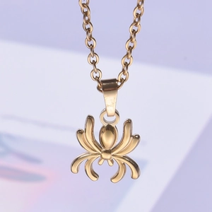 Detailed close-up of golden spider pendant with 18k gold plating on a stainless steel chain