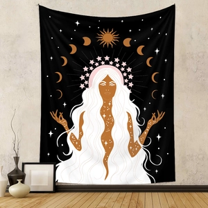 Detail of bohemian tapestry featuring goddess, moon phases and celestial sun patterns