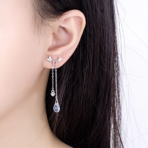 Silver butterfly drop earrings with moonstone and chain tassels on female model