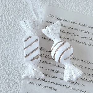 White acrylic candy Christmas tree ornaments with silver glitter stripes and silk hanging ropes