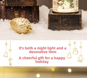 Close-up of a Christmas snowman snow globe lamp with a pine cone and warm festive lights