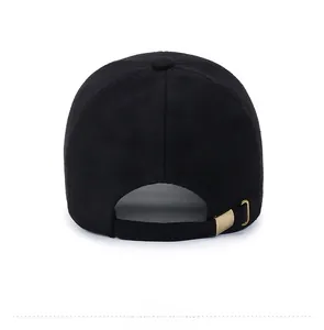 Rear view of black wool baseball cap with adjustable gold metal buckle and fleece texture