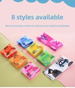 Flat lay of eight colorful early learning cloth books for baby sensory development