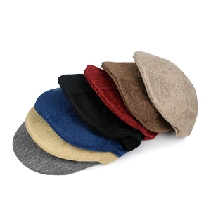 Close-up showing the knit texture and various colors of cotton linen flat caps